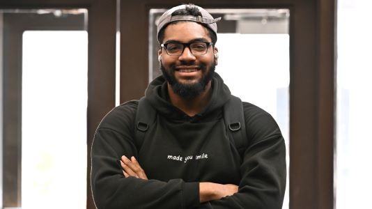 Smiling student inside the KCC main entrance